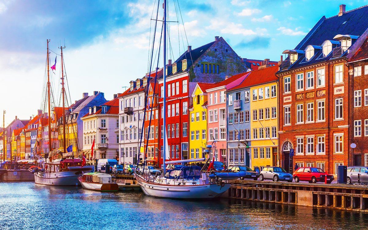 Colourful houses and sailing ships along Nyhavn in Copenhagen
